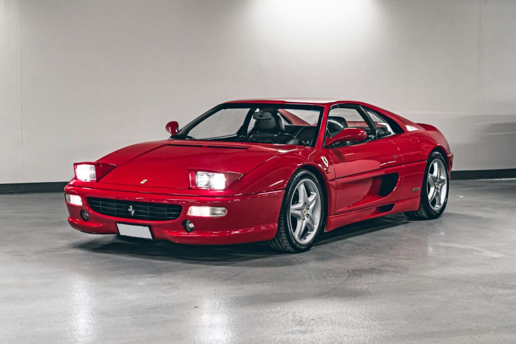 A red Ferrari F355 Investment car parked