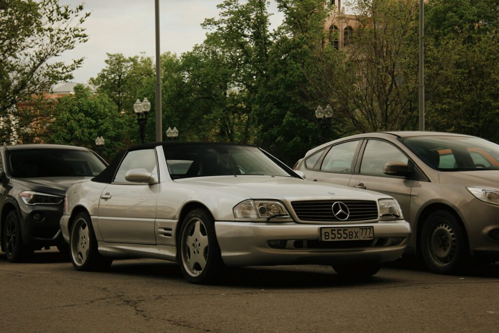 Silver Mercedes R129 roadster parked.