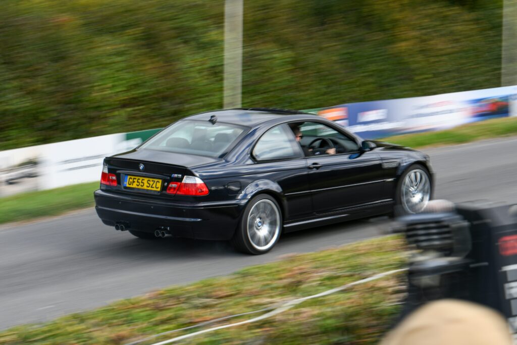 A rear three-quarter view of a black BMW E46 M3.