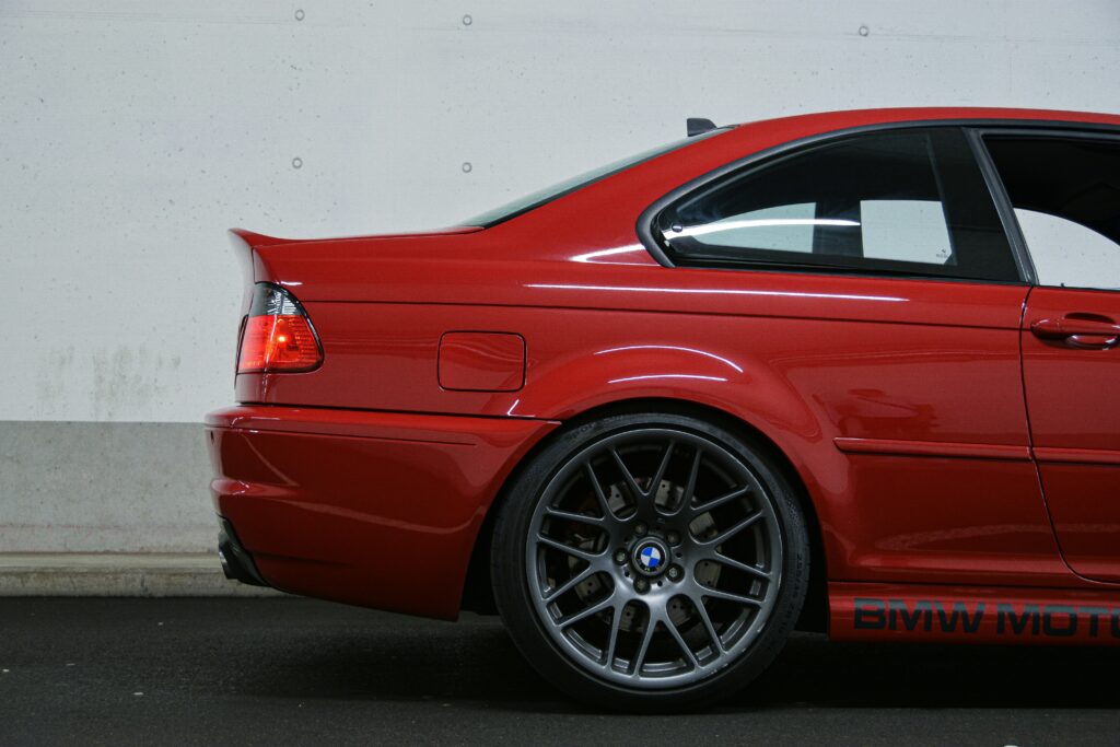 A rear right end view of a red BMW E46 M3
