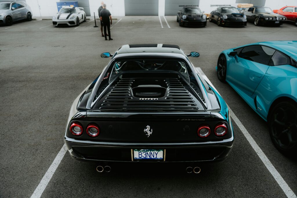 A rear-end shot of a black Ferrari F355.