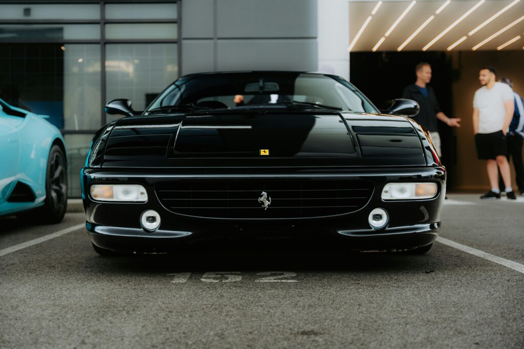 A front-end shot of a black Ferrari F355.