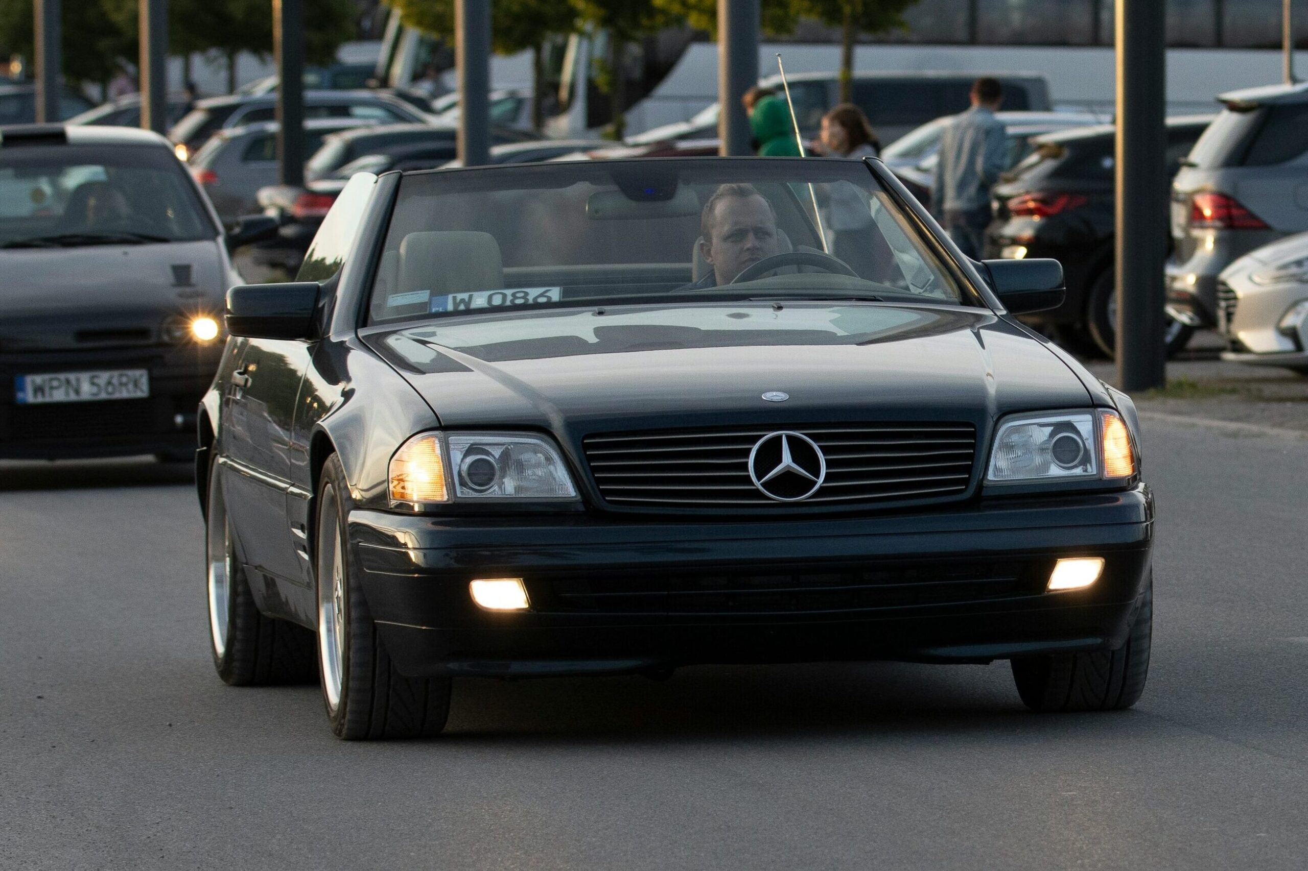 Black Mercedes R129 driving.