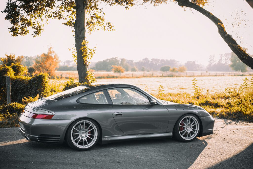 A 996 Carrera parked near a treeline.