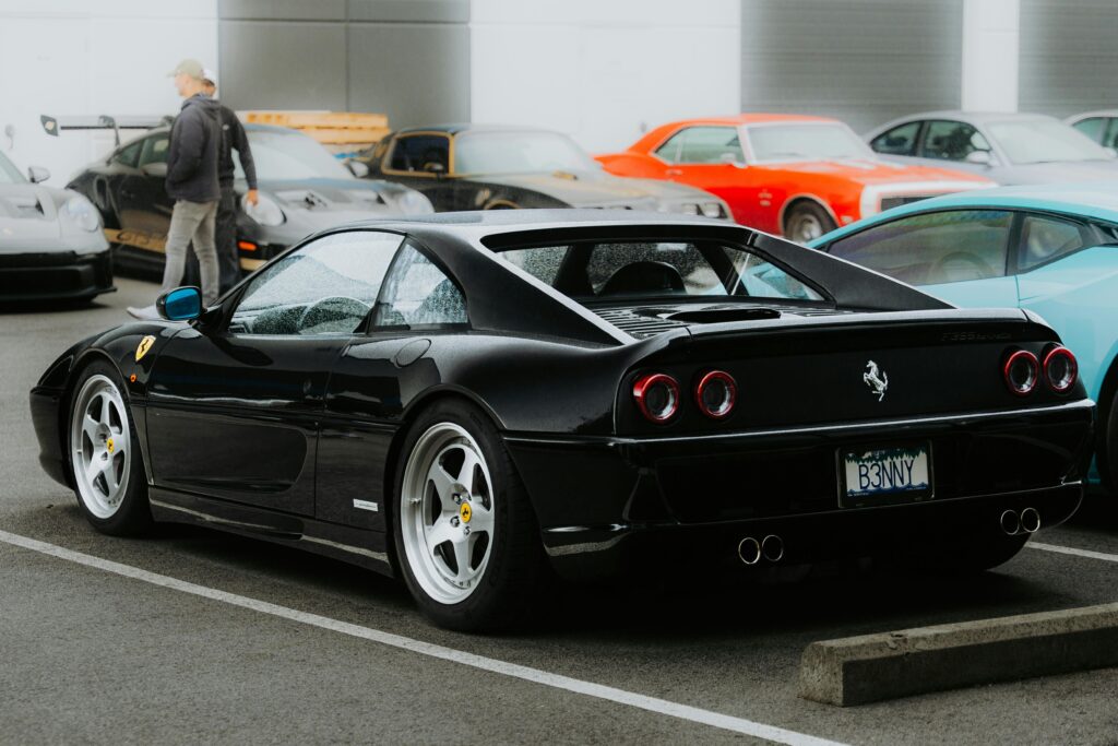 A rear-end shot of a black Ferrari F355.