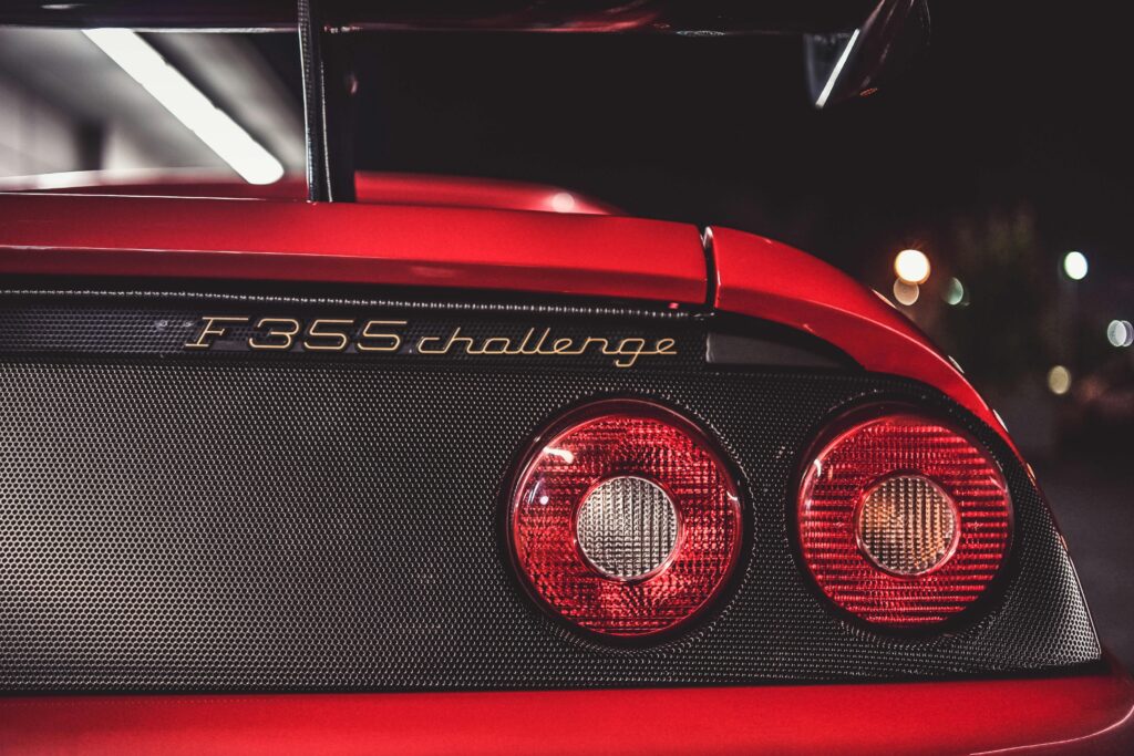 A close-up of a Ferrari F355 Challenge rear badge.