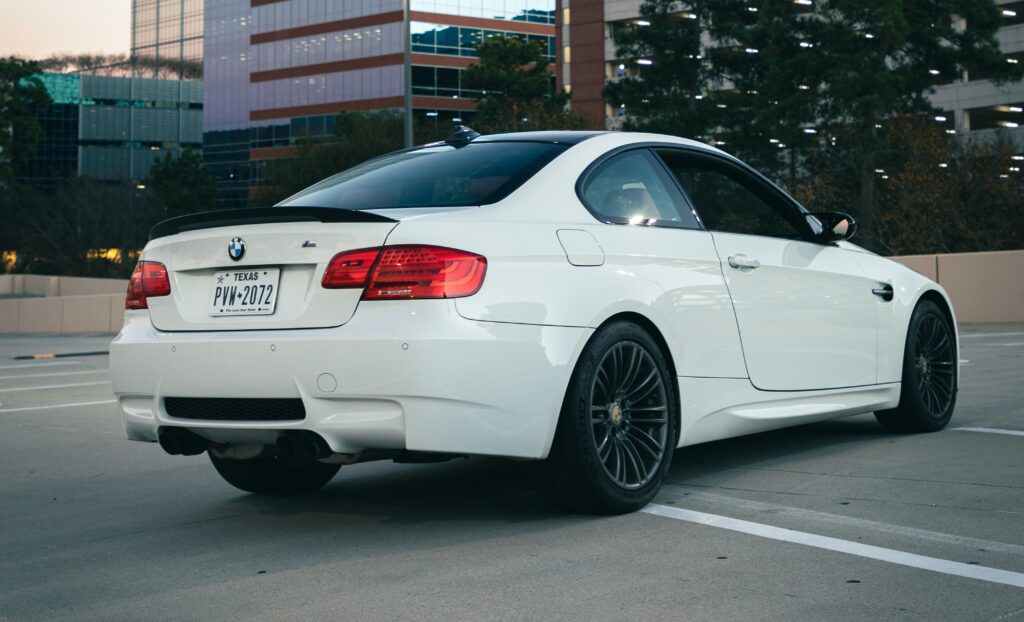A rear three-quarter view of a white BMW E92 M3.