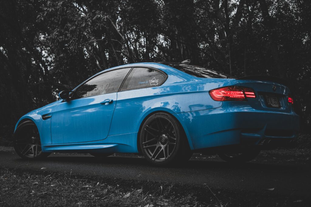 A rear three-quarter view of a blue BMW E92 M3.