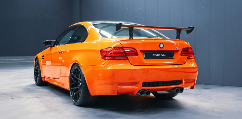 An orange BMW E92 M3 GTS parked on display from behind