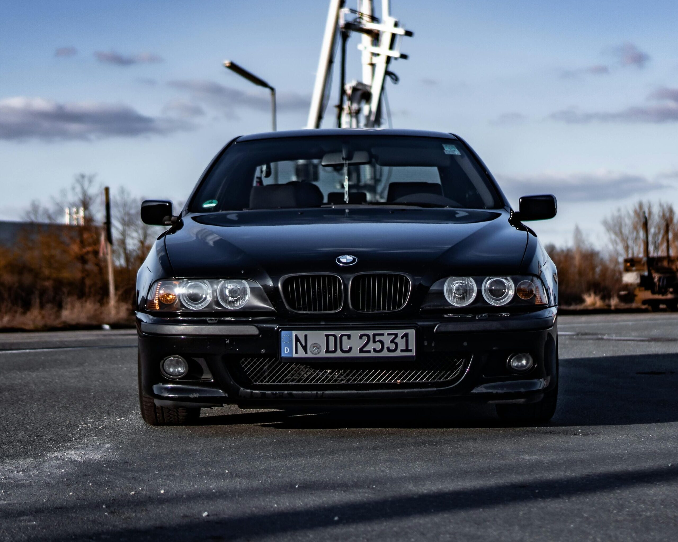 A front-end view of a black BMW E39 M5.