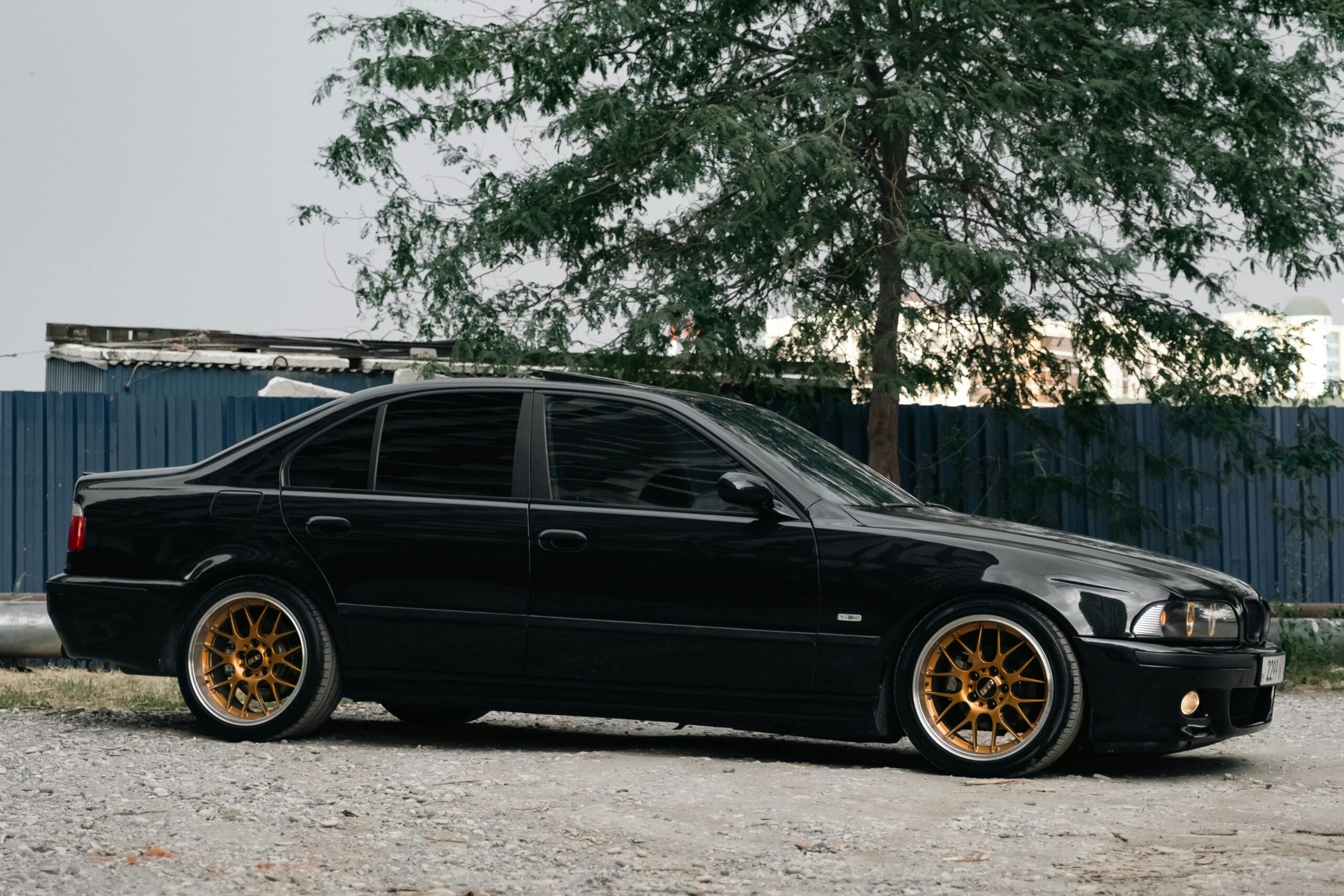 A side profile view of a black E39 BMW M5.