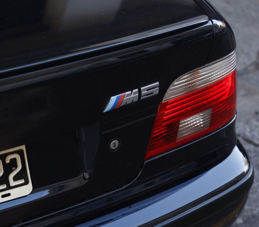 A close-up of a BMW E39 M5 rear badge.