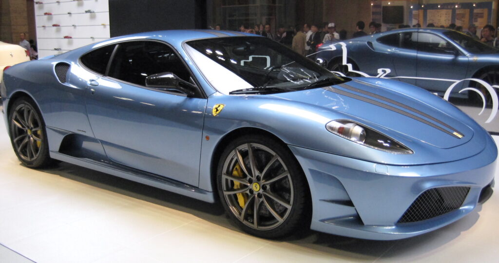 A light blue Ferrari F430 Scuderia parked on display.