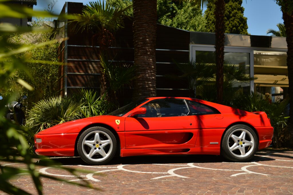 A side profile view of a red Ferrari F355.