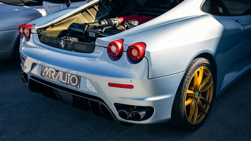 A Ferrari F430 Scuderia with its engine bay open.