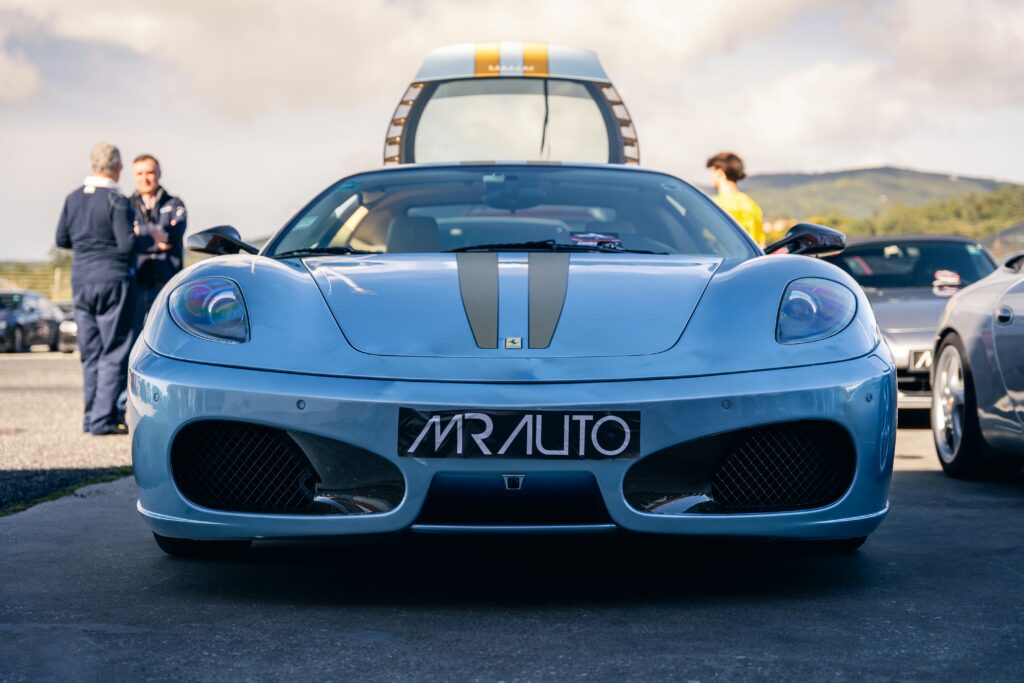 A front-end shot of a light blue Ferrari F430 Scuderia