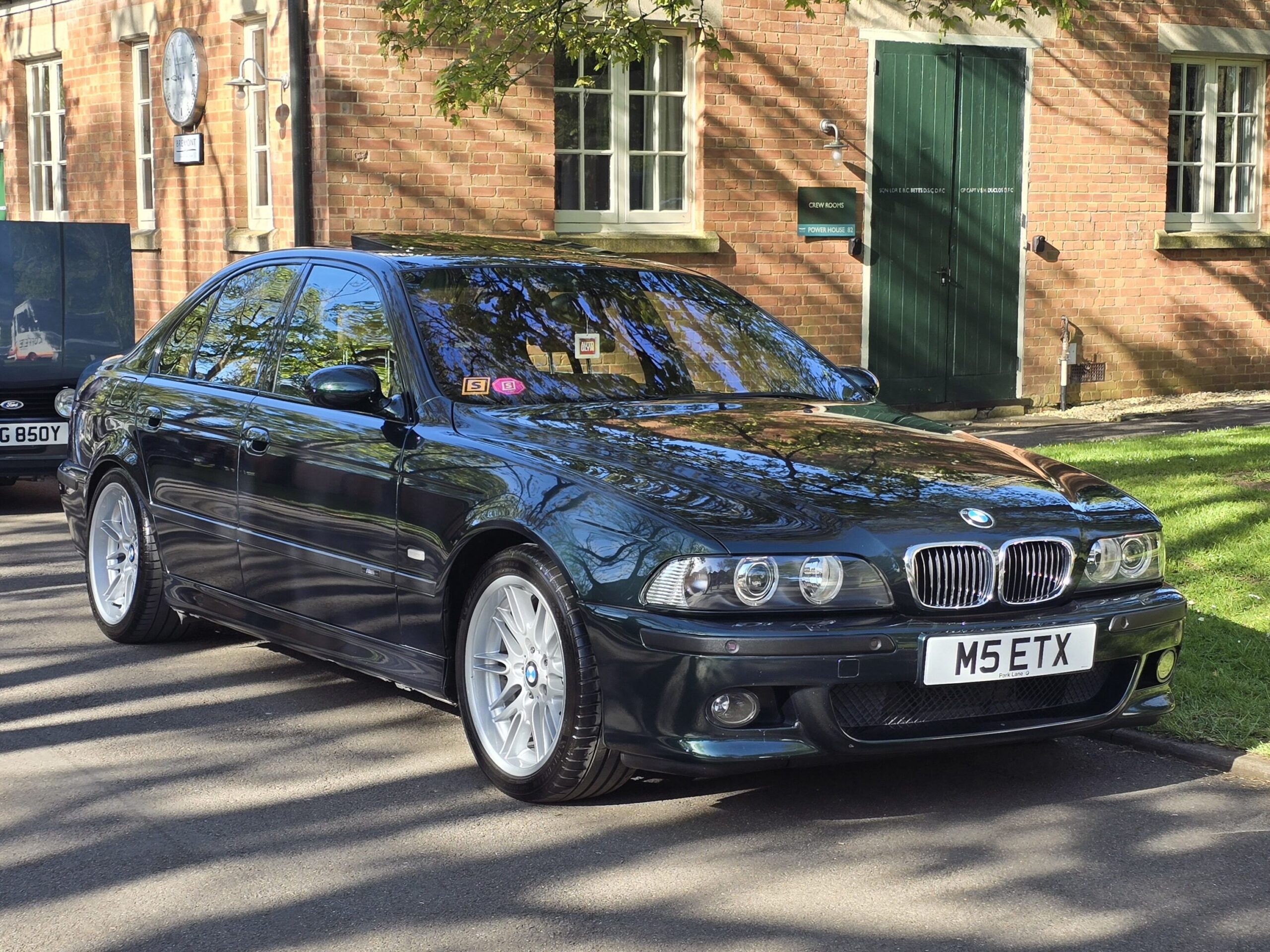 A dark green BMW E39 M5 parked.