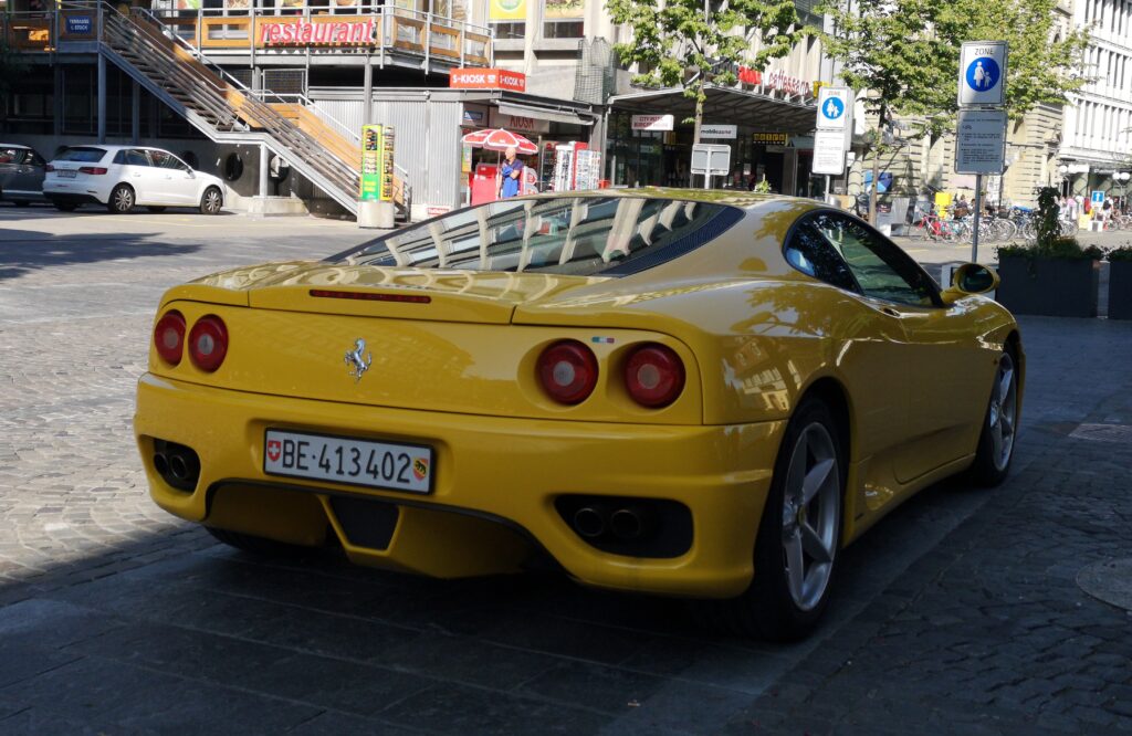 A rear end of a yellow Ferrari 360