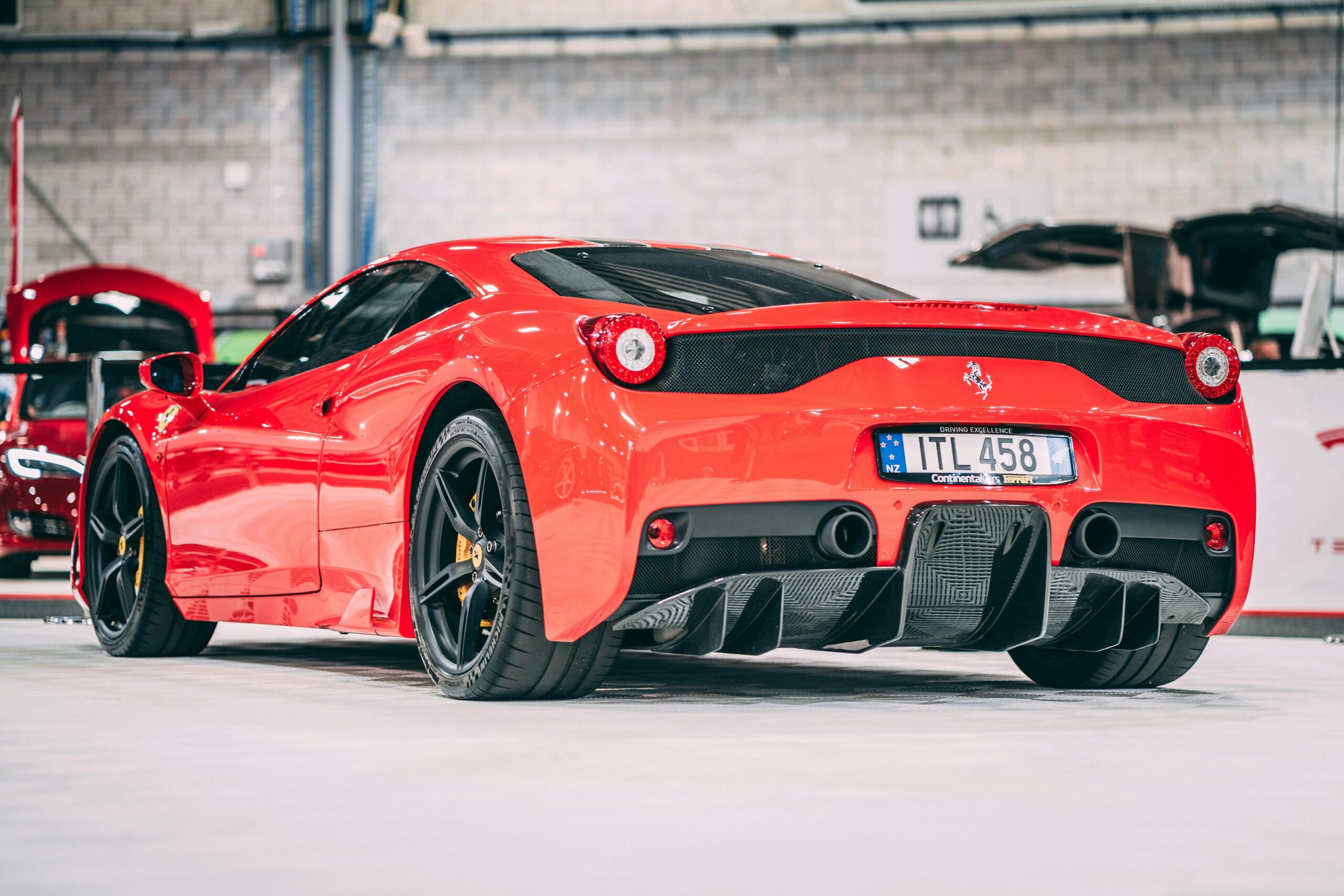 A rear three quarter view of a red Ferrari 458 Speciale