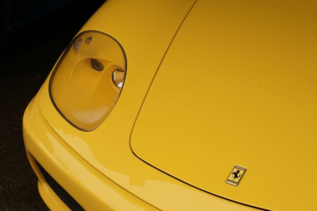 A close-up of a yellow Ferrari 360 hood.