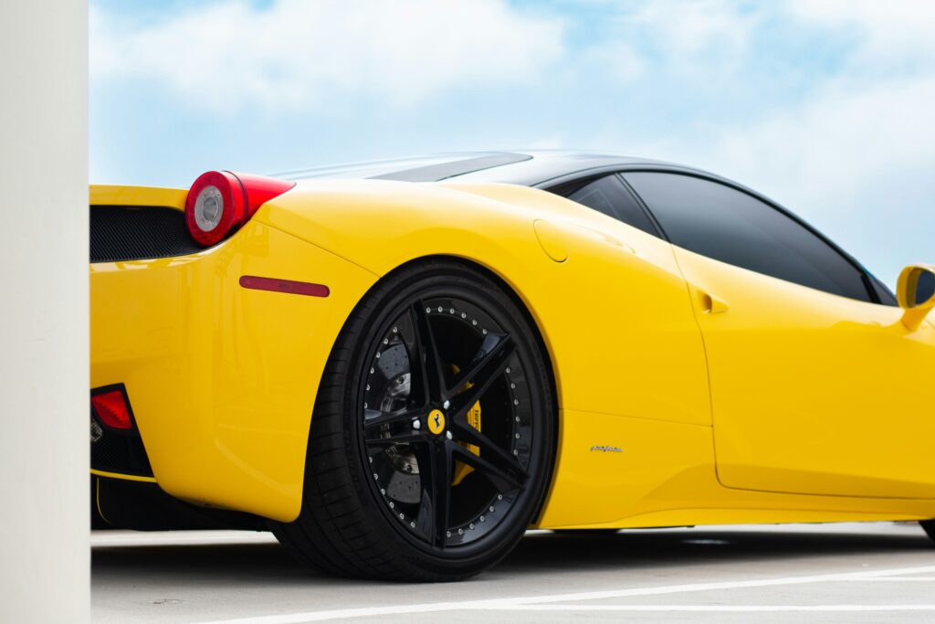 A rear three-quarter view of a yellow Ferrari 458