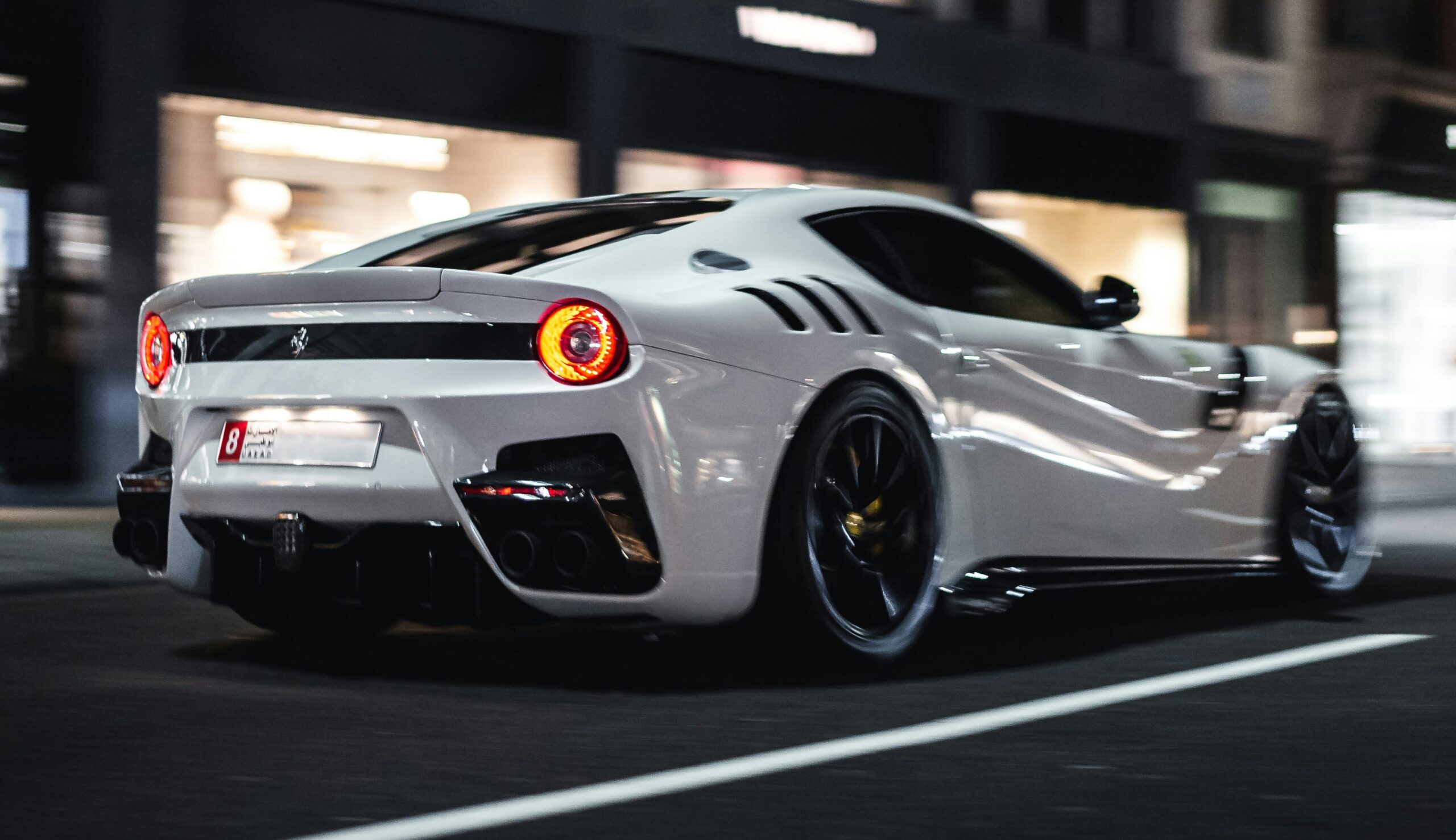 A rear three-quarter shot of a Ferrari F12 TDF in motion
