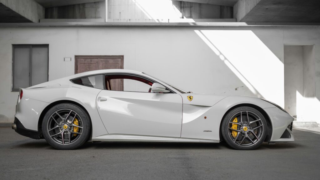 A side profile view of a white Ferrari F12.