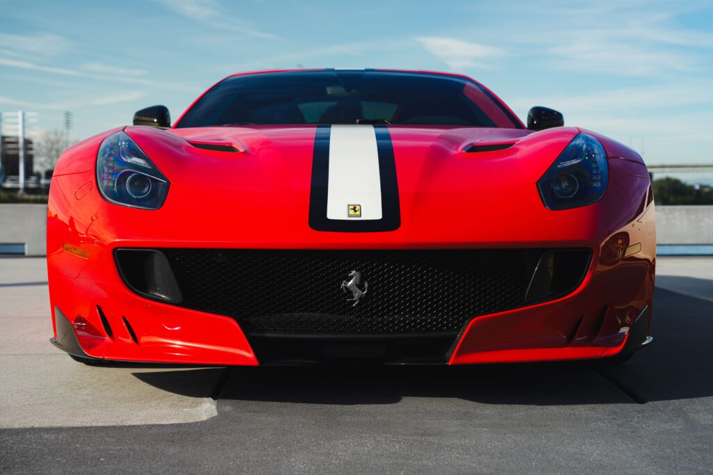 A red Ferrari F12 investment car from the front.